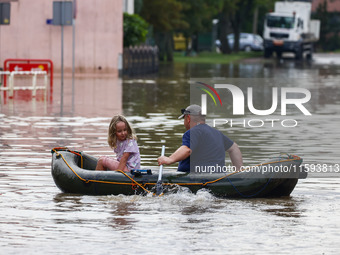 Residents swim on a raft after Nysa Klodzka river flooded town of Lewin Brzeski in southwestern Poland, on September 19th, 2024. Storm Boris...