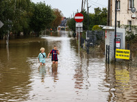 Children walk in the water after Nysa Klodzka river flooded town of Lewin Brzeski in southwestern Poland, on September 19th, 2024. Storm Bor...