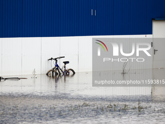 A bicycle is seen in the water after Nysa Klodzka river flooded town of Lewin Brzeski in southwestern Poland, on September 19th, 2024. Storm...