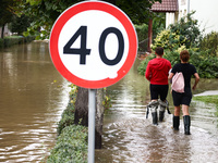 Residents walk in the water after Nysa Klodzka river flooded town of Lewin Brzeski in southwestern Poland, on September 19th, 2024. Storm Bo...