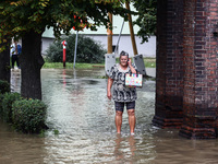 A woman walks in the water after Nysa Klodzka river flooded town of Lewin Brzeski in southwestern Poland, on September 19th, 2024. Storm Bor...