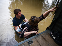 A woman walks into the water to reach her hoase after Nysa Klodzka river flooded town of Lewin Brzeski in southwestern Poland, on September...