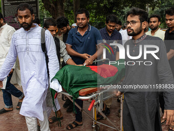 People carry the body of Nayon Mia (25), who dies 48 days after being shot during the Anti-discrimination Student Movement, to perform his f...