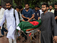 People carry the body of Nayon Mia (25), who dies 48 days after being shot during the Anti-discrimination Student Movement, to perform his f...