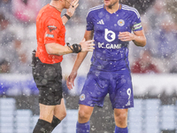 Referee Darren England speaks to #9, Jamie Vardy of Leicester City during the Premier League match between Leicester City and Everton at the...