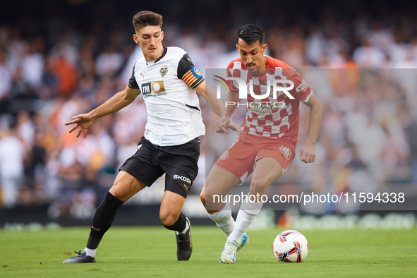 Pepelu of Valencia CF competes for the ball with Bojan Miovski of Girona FC during the LaLiga EA Sports match between Valencia CF and Girona...