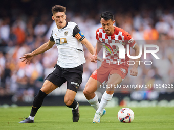 Pepelu of Valencia CF competes for the ball with Bojan Miovski of Girona FC during the LaLiga EA Sports match between Valencia CF and Girona...