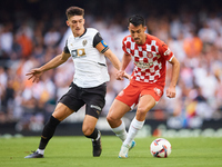 Pepelu of Valencia CF competes for the ball with Bojan Miovski of Girona FC during the LaLiga EA Sports match between Valencia CF and Girona...