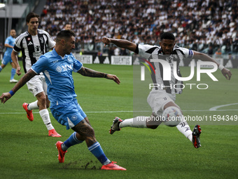 Juventus defender Bremer (3) tackles Napoli forward Matteo Politano (21) during the Serie A football match number 5 between Juventus and Nap...