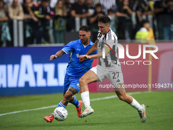 Juventus defender Andrea Cambiaso (27) fights for the ball against Napoli forward Matteo Politano (21) during the Serie A football match num...