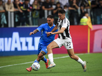 Juventus defender Andrea Cambiaso (27) fights for the ball against Napoli forward Matteo Politano (21) during the Serie A football match num...