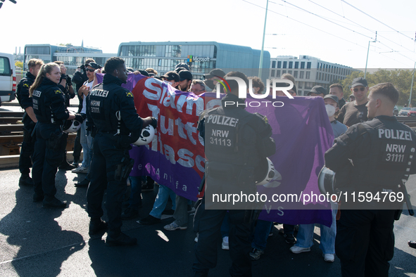 Police approach the dozen counter-protesters who block the street as thousands of people take part in the annual pro-life demonstration orga...