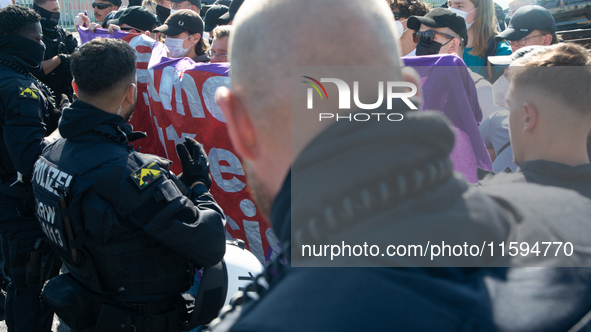 Police approach the dozen counter-protesters who block the street as thousands of people take part in the annual pro-life demonstration orga...