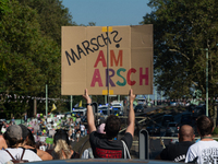 Several counter-protesters hold a sign reading ''March on the Ass'' as thousands of people take part in an annual pro-life demonstration org...