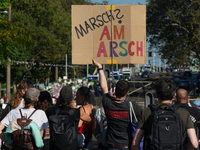 Several counter-protesters hold a sign reading ''March on the Ass'' as thousands of people take part in an annual pro-life demonstration org...