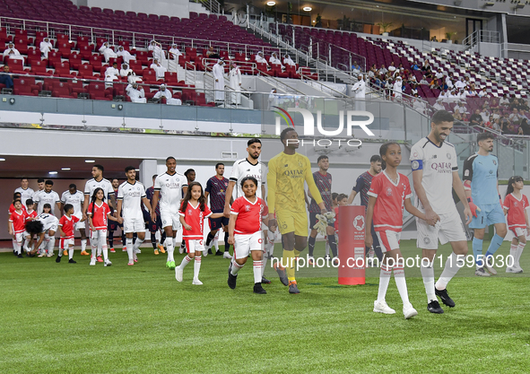 Players of Al Sadd SC and Al Duhail SC walk onto the pitch before the Ooredoo Qatar Stars League 24/25 match between Al Sadd SC and Al Duhai...