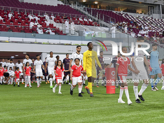 Players of Al Sadd SC and Al Duhail SC walk onto the pitch before the Ooredoo Qatar Stars League 24/25 match between Al Sadd SC and Al Duhai...