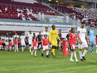 Players of Al Sadd SC and Al Duhail SC walk onto the pitch before the Ooredoo Qatar Stars League 24/25 match between Al Sadd SC and Al Duhai...