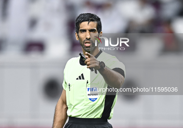 Referee Khamis Mohammed Al-Marri gestures during the Ooredoo Qatar Stars League 24/25 match between Al-Sadd SC and Al Duhail SC at Khalifa I...