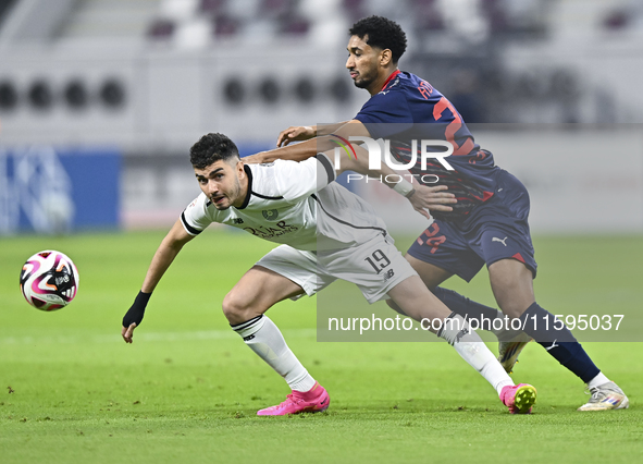 Rafael Sebastian Mujica Garcia (L) of Al-Sadd SC battles for the ball with Homam El Amin (R) of Duhail SC during the Ooredoo Qatar Stars Lea...