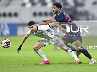 Rafael Sebastian Mujica Garcia (L) of Al-Sadd SC battles for the ball with Homam El Amin (R) of Duhail SC during the Ooredoo Qatar Stars Lea...