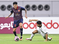 Abdulla Badr Alyazidi (R) of Al-Sadd SC battles for the ball with Edmilson Junior Paulo (L) of Duhail SC during the Ooredoo Qatar Stars Leag...