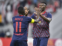 Michael Olunga (R) of Al Duhail SC celebrates after scoring a goal during the Ooredoo Qatar Stars League 24/25 match between Al-Sadd SC and...