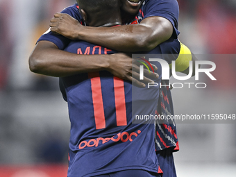 Michael Olunga (R) of Al Duhail SC celebrates after scoring a goal during the Ooredoo Qatar Stars League 24/25 match between Al-Sadd SC and...