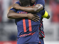 Michael Olunga (R) of Al Duhail SC celebrates after scoring a goal during the Ooredoo Qatar Stars League 24/25 match between Al-Sadd SC and...