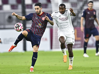 Mohamed Camara (R) of Al-Sadd SC battles for the ball with Luis Alberto (L) of Duhail SC during the Ooredoo Qatar Stars League 24/25 match b...