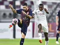 Mohamed Camara (R) of Al-Sadd SC battles for the ball with Luis Alberto (L) of Duhail SC during the Ooredoo Qatar Stars League 24/25 match b...