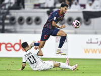 Abdulla Badr Alyazidi (L) of Al-Sadd SC battles for the ball with Homam El Amin (R) of Duhail SC during the Ooredoo Qatar Stars League 24/25...