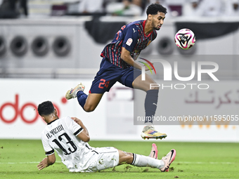 Abdulla Badr Alyazidi (L) of Al-Sadd SC battles for the ball with Homam El Amin (R) of Duhail SC during the Ooredoo Qatar Stars League 24/25...