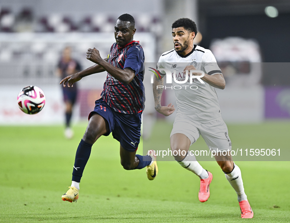 Paulo Silva (R) of Al-Sadd SC battles for the ball with Almoez Abdulla (L) of Duhail SC during the Ooredoo Qatar Stars League 24/25 match be...