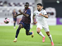 Paulo Silva (R) of Al-Sadd SC battles for the ball with Almoez Abdulla (L) of Duhail SC during the Ooredoo Qatar Stars League 24/25 match be...