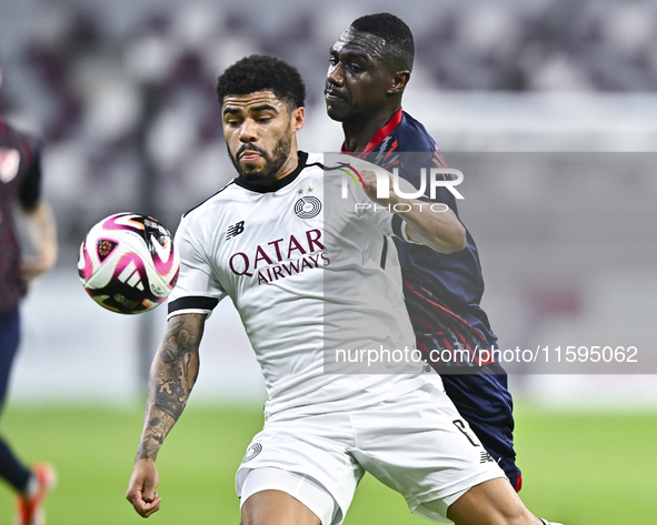 Paulo Silva (L) of Al-Sadd SC battles for the ball with Almoez Abdulla (R) of Duhail SC during the Ooredoo Qatar Stars League 24/25 match be...