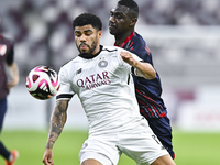 Paulo Silva (L) of Al-Sadd SC battles for the ball with Almoez Abdulla (R) of Duhail SC during the Ooredoo Qatar Stars League 24/25 match be...