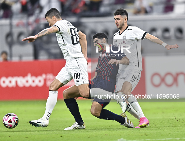 Rafael Sebastian Mujica Garcia of Al-Sadd SC battles for the ball with Karim Buddaif of Duhail SC during the Ooredoo Qatar Stars League 24/2...