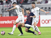 Rafael Sebastian Mujica Garcia of Al-Sadd SC battles for the ball with Karim Buddaif of Duhail SC during the Ooredoo Qatar Stars League 24/2...