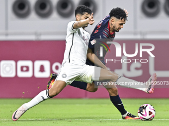 Abdulla Badr Alyazidi (L) of Al-Sadd SC battles for the ball with Edmilson Junior Paulo (R) of Duhail SC during the Ooredoo Qatar Stars Leag...