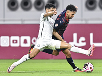 Abdulla Badr Alyazidi (L) of Al-Sadd SC battles for the ball with Edmilson Junior Paulo (R) of Duhail SC during the Ooredoo Qatar Stars Leag...