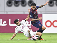 Abdulla Badr Alyazidi (L) of Al-Sadd SC battles for the ball with Edmilson Junior Paulo (R) of Duhail SC during the Ooredoo Qatar Stars Leag...