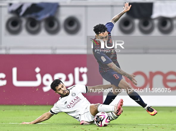 Abdulla Badr Alyazidi (L) of Al-Sadd SC battles for the ball with Edmilson Junior Paulo (R) of Duhail SC during the Ooredoo Qatar Stars Leag...