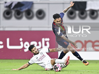 Abdulla Badr Alyazidi (L) of Al-Sadd SC battles for the ball with Edmilson Junior Paulo (R) of Duhail SC during the Ooredoo Qatar Stars Leag...