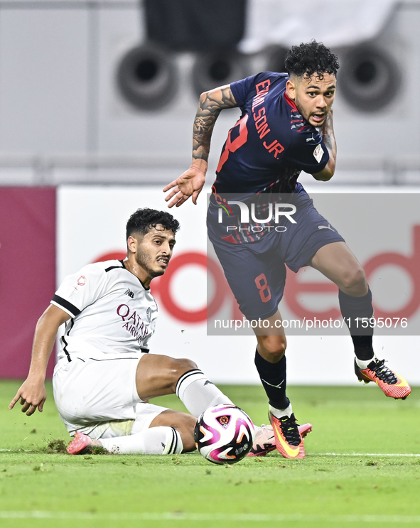 Abdulla Badr Alyazidi (L) of Al-Sadd SC battles for the ball with Edmilson Junior Paulo (R) of Duhail SC during the Ooredoo Qatar Stars Leag...