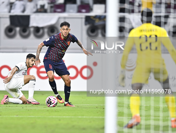 Abdulla Badr Alyazidi (L) of Al-Sadd SC battles for the ball with Edmilson Junior Paulo (R) of Duhail SC during the Ooredoo Qatar Stars Leag...