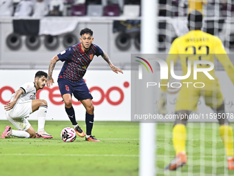 Abdulla Badr Alyazidi (L) of Al-Sadd SC battles for the ball with Edmilson Junior Paulo (R) of Duhail SC during the Ooredoo Qatar Stars Leag...