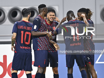 Edmilson Junior Paulo (C) of Al Duhail SC celebrates after scoring a goal during the Ooredoo Qatar Stars League 24/25 match between Al-Sadd...