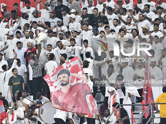 Fans of Al Duhail SC cheer for their team during the Ooredoo Qatar Stars League 24/25 match between Al-Sadd SC and Al Duhail SC at Khalifa I...