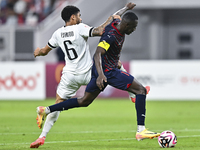 Paulo Silva (L) of Al-Sadd SC battles for the ball with Almoez Abdulla (R) of Duhail SC during the Ooredoo Qatar Stars League 24/25 match be...